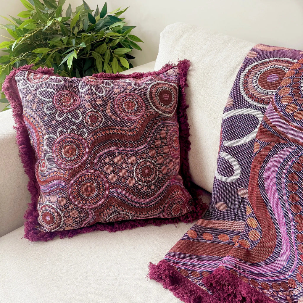 Sand Dreaming Cushion Cover styled in reading corner — Aboriginal art cushion cover pairs with Sand Dreaming Throw for coordinated classroom look
