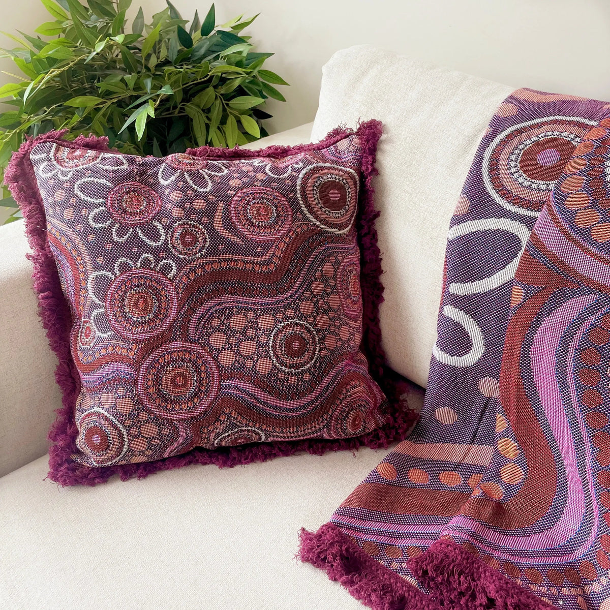 Sand Dreaming Cushion Cover styled in reading corner — Aboriginal art cushion cover pairs with Sand Dreaming Throw for coordinated classroom look