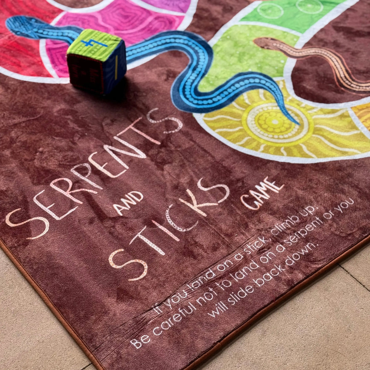 Serpents and Sticks Rug Game with soft Dice — children playing rug game in classroom