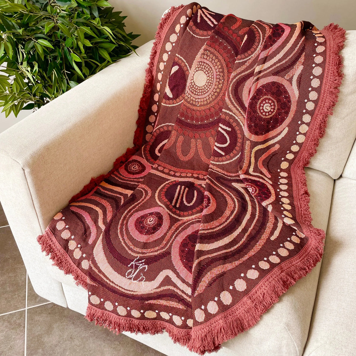 Yarning Circle Cotton Throw draped in reading corner — Aboriginal art cotton throw for classroom library and reading spaces