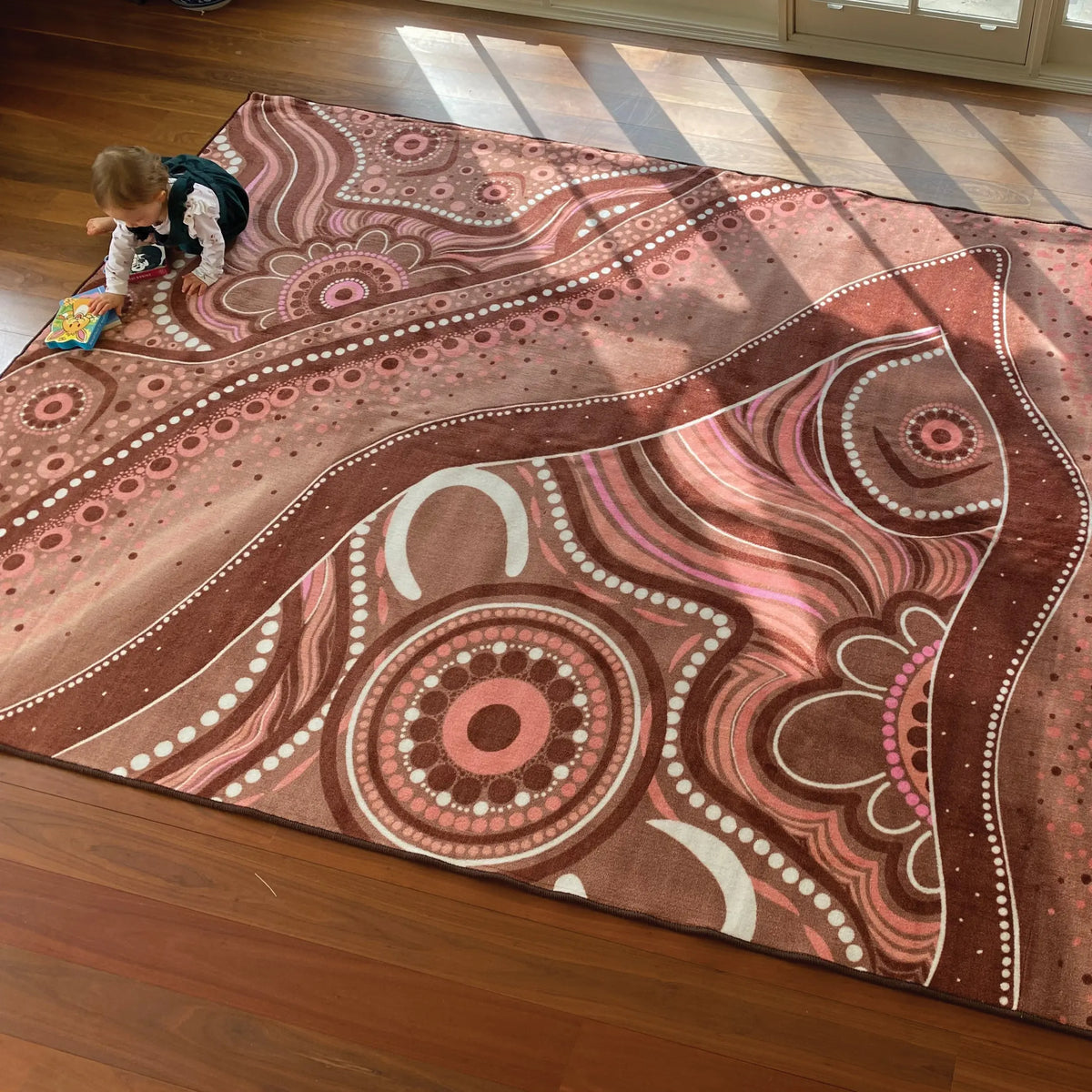 Aboriginal Art Desert Dreaming rug in classroom — children sitting on Indigenous art rug during group learning time